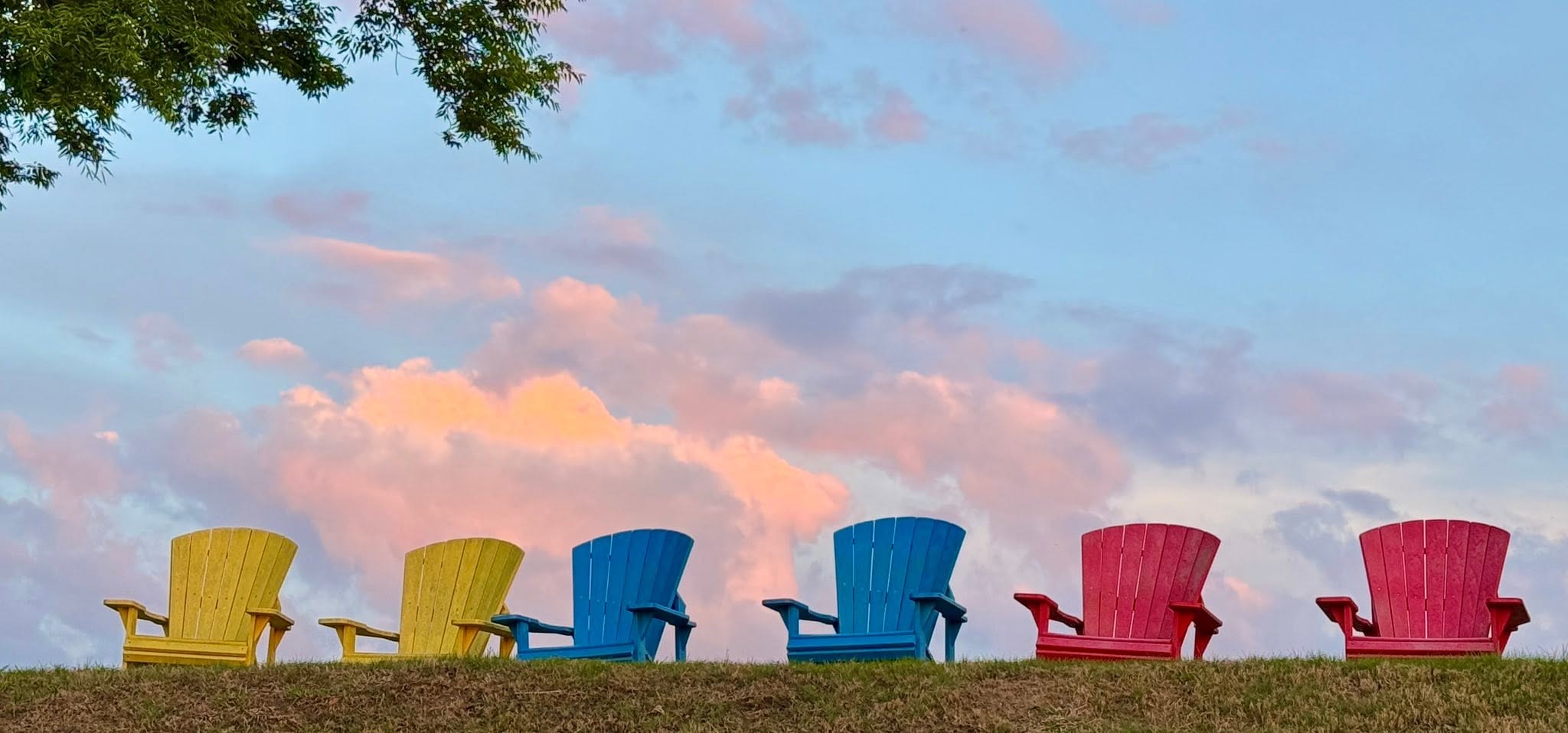 Colorful Adirondack chairs overlooking the Albemarle Sound at Occano