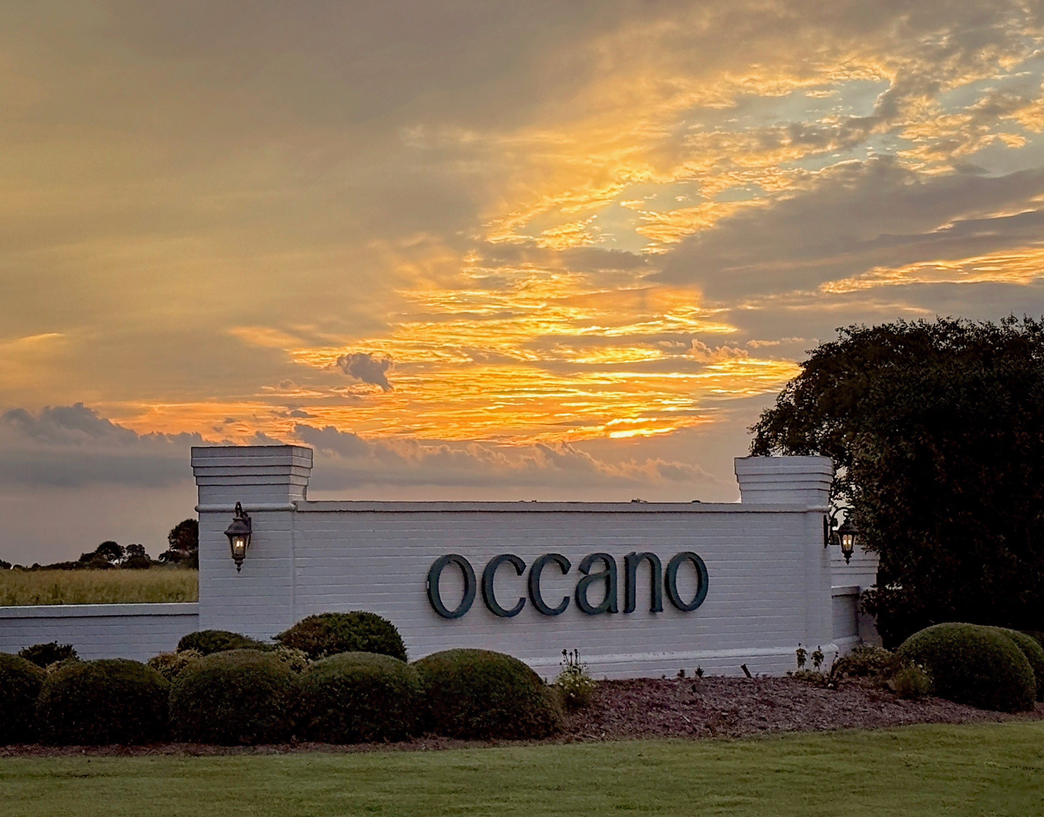 Occano community entrance sign at sunset
